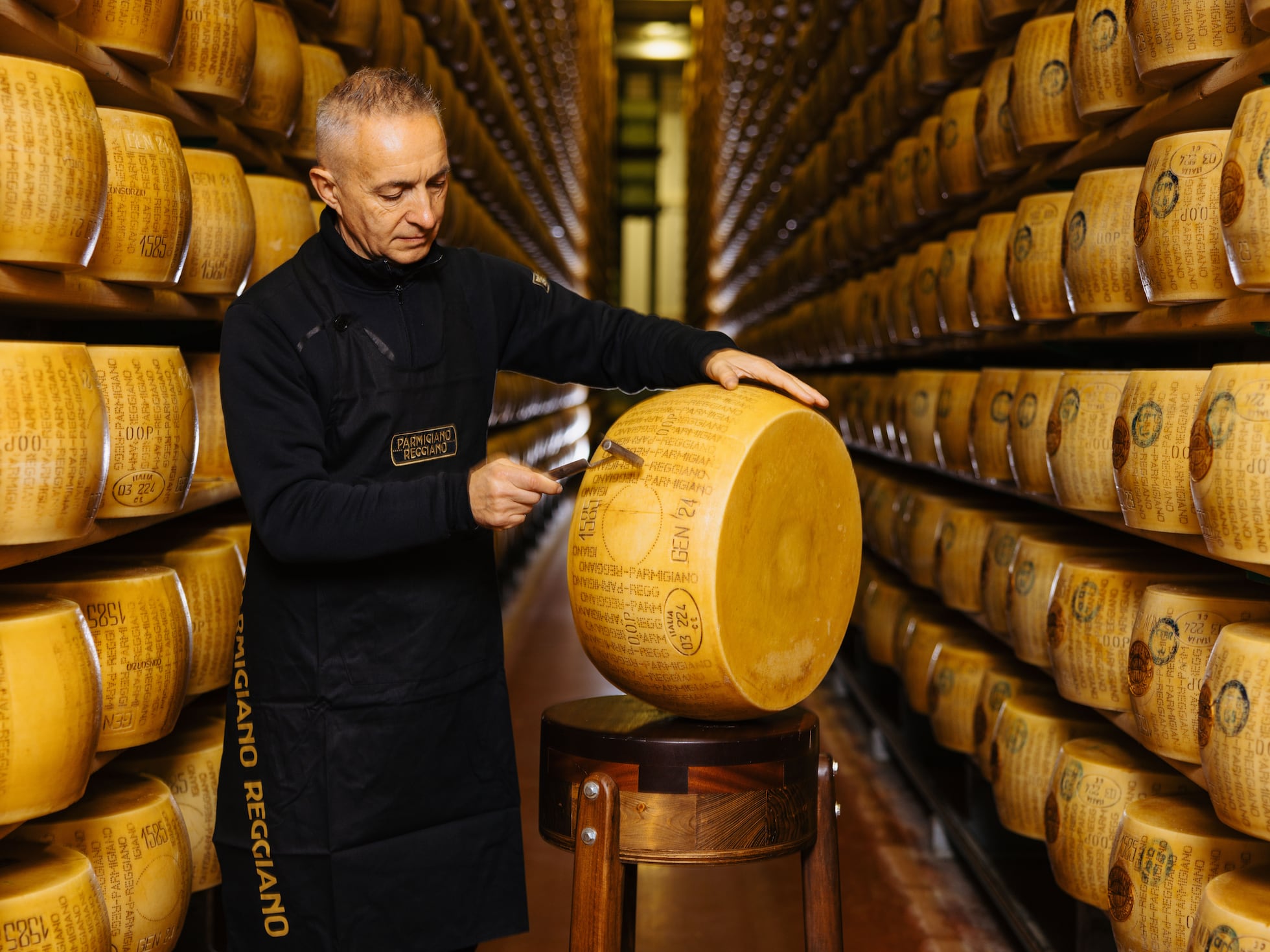 Parmigiano-Reggiano wheels aging in a warehouse — Heapio